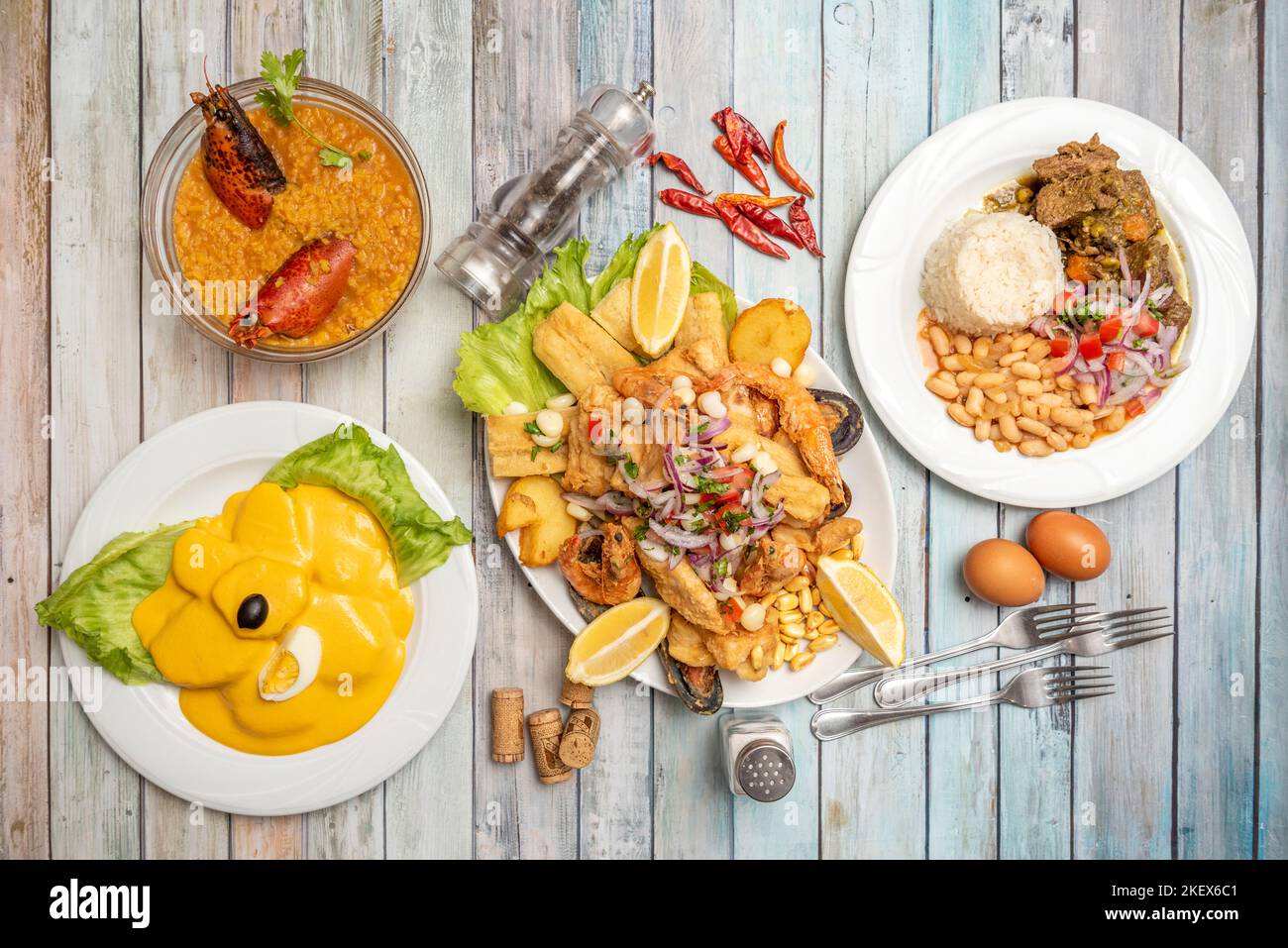 Typical dishes of Peruvian cuisine with a fish and seafood jelly, huancaina potatoes, rice with lobster, rice and meat with white beans Stock Photo