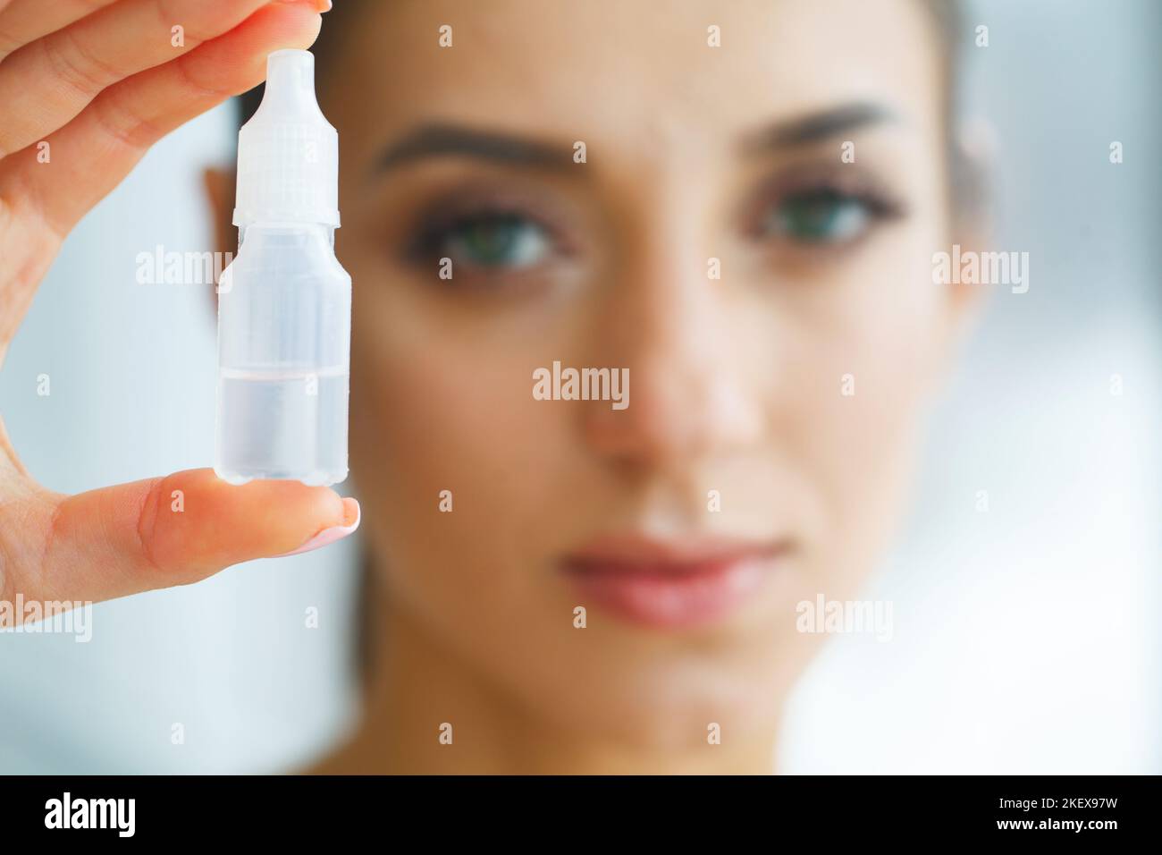 Vision And Medicine Concept. Young Girl Holds Eye Drops In Hands