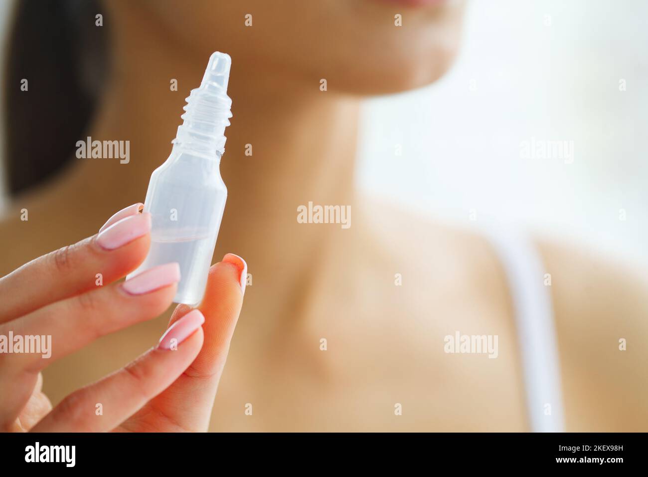 Vision And Medicine Concept. Young Girl Holds Eye Drops In Hands