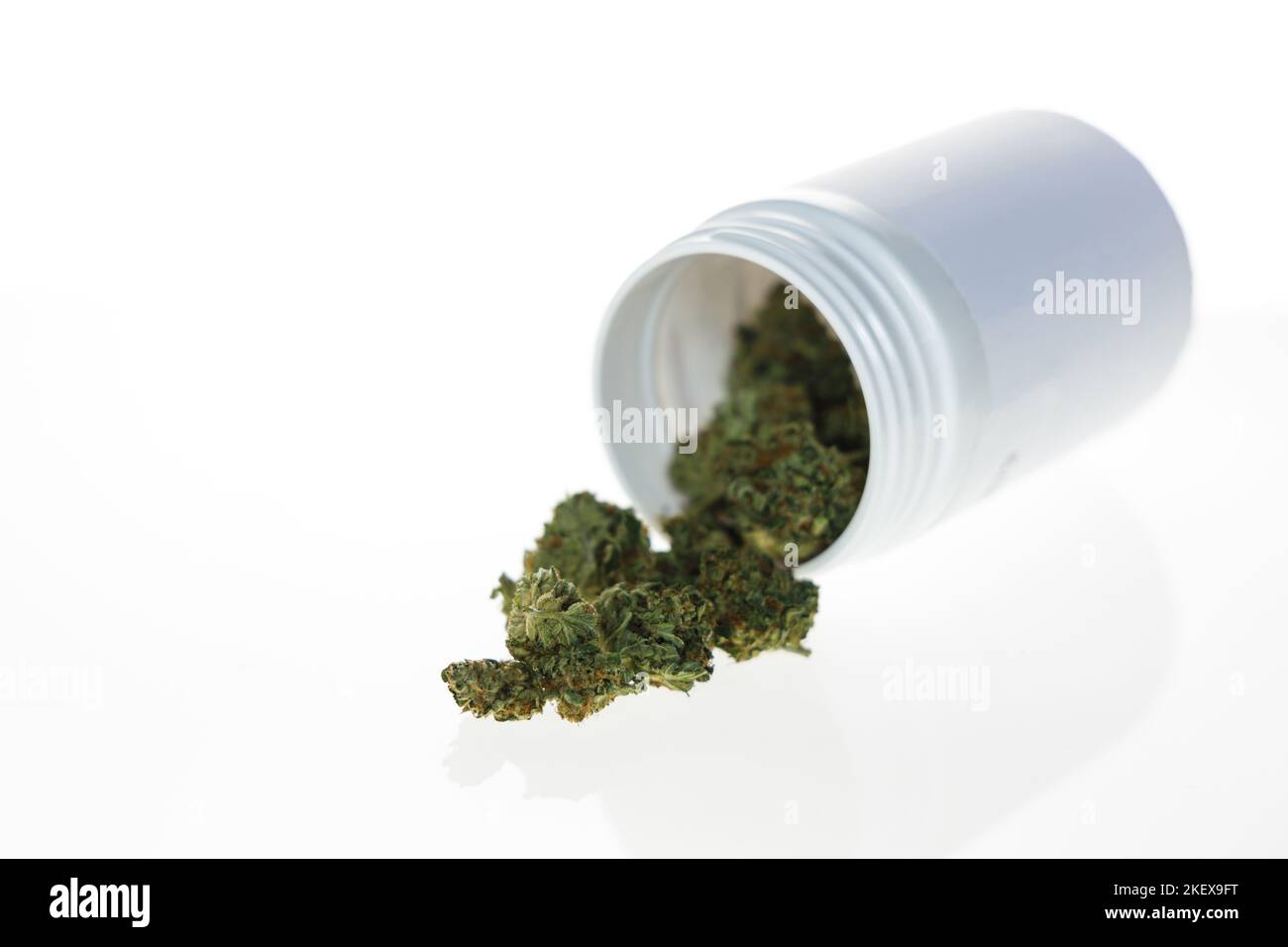 Cannabis flos, medical marijuana in white container on white background Stock Photo