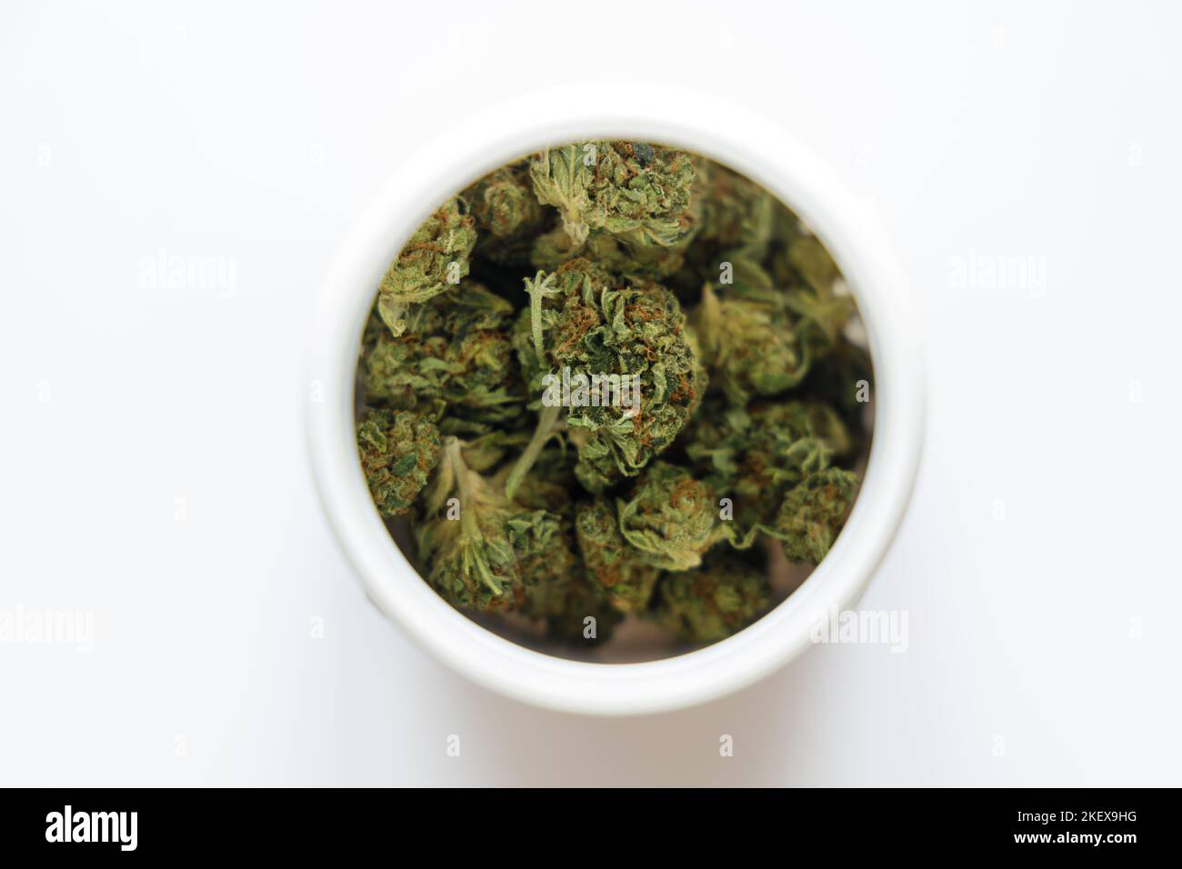 Cannabis flos, medical marijuana in white container Stock Photo