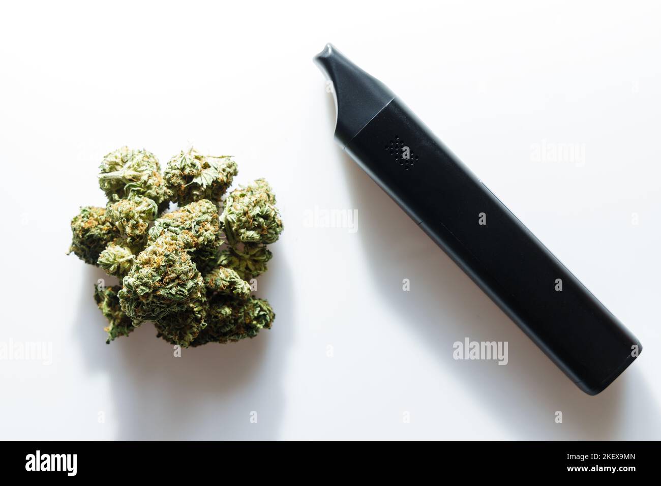 Cannabis flos, medical marijuana pile next to vaporizer, safe way to take medicine Stock Photo