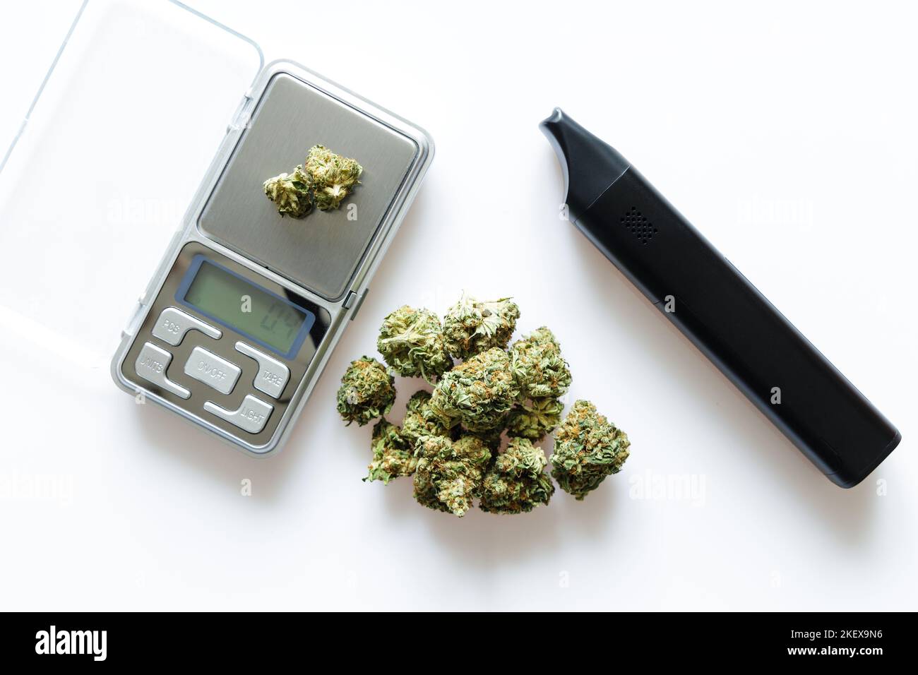 Cannabis flos, medical marijuana pile next to vaporizer and precision scale, safe way to take medicine Stock Photo