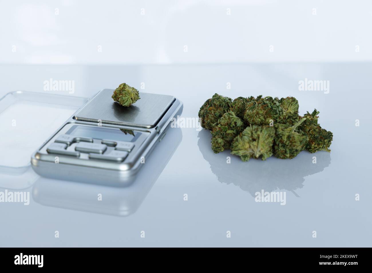 Cannabis flos, medical marijuana pile next to precision scale, safe way to take medicine Stock Photo
