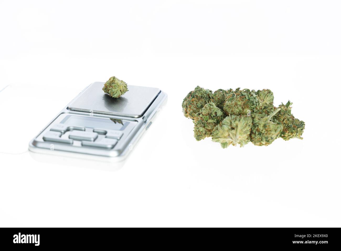 Cannabis flos, medical marijuana pile next to precision scale, safe way to take medicine Stock Photo