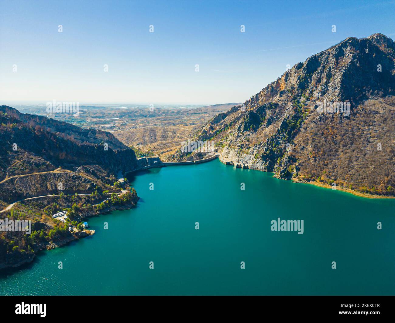 Rocky mountains above Oymapinar Lake, Turkey in the morning. Deep blue water lake. Blurred hills in the distance. Scenic view. Horizontal shot. High quality photo Stock Photo