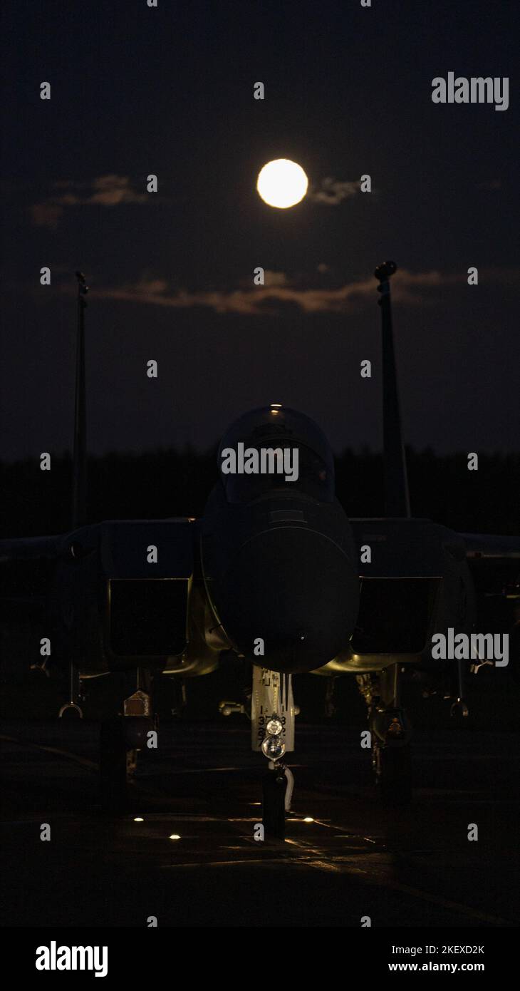 An F-15E Strike Eagle assigned to the 492nd Fighter Squadron sits on the arming pad prior to takeoff at Royal Air Force Lakenheath, England, Nov. 8, 2022. Night flying enables aircrew to harness and maintain their readiness should they be called at a moment’s notice. (U.S. Air Force photo by Staff Sgt. Gaspar Cortez) Stock Photo