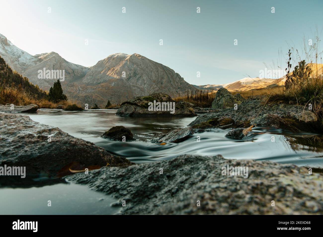 River crossing a valley with a mountain in the background Stock Photo