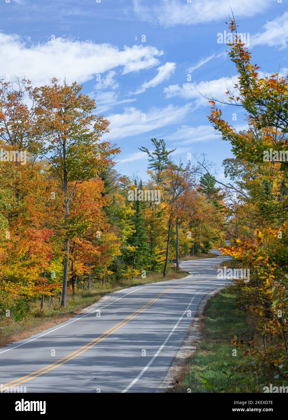 Wisconsin Highway 42 curves and winds it's way through the forest in autumn as it follows the lay of the land, Door County, Wisconsin Stock Photo