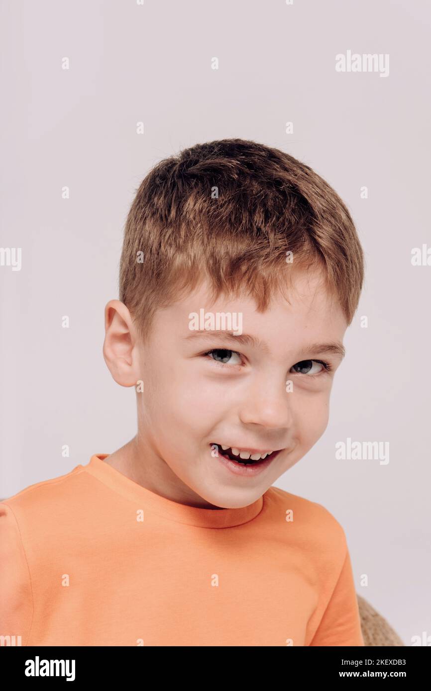 Emotional portrait of 5 boy wearing orange tshirt Stock Photo Alamy