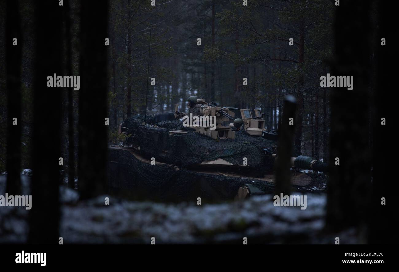 U.S. Soldiers of 6th Squadron, 9th Cavalry Regiment, 3rd Armored Brigade Combat Team, 1st Cavalry Division (3-1 ABCT), operationally assigned to the 1st Infantry Division (1 ID), in an Abrams M1A2 System Enhancement Package version 3 tank guard a road during Hammer 22, an annual combined forces exercise conducted by and alongside Finland’s Army Headquarters, Armored Brigade, Pori Brigade, Karelia Brigade, Uti Jaeger Regiment and Logistics Department of the Defense Forces, in Niinisalo, Finland, Nov. 9, 2022. The 3-1 ABCT is among other units under the 1 ID proudly working alongside allies and Stock Photo