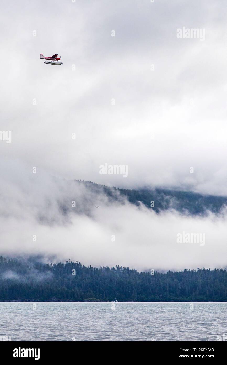 Floatplane in cloudy weather; Valdez Arm; Prince William Sound; Alaska; USA Stock Photo