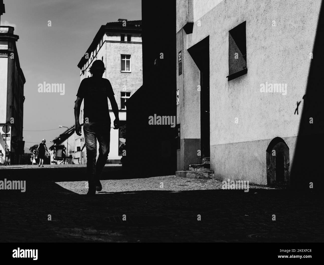 silhouette of the man on the street of small town, people on the