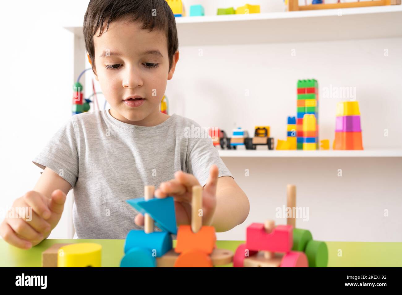 Shot of a child with wooden toy. The child collects a sorter