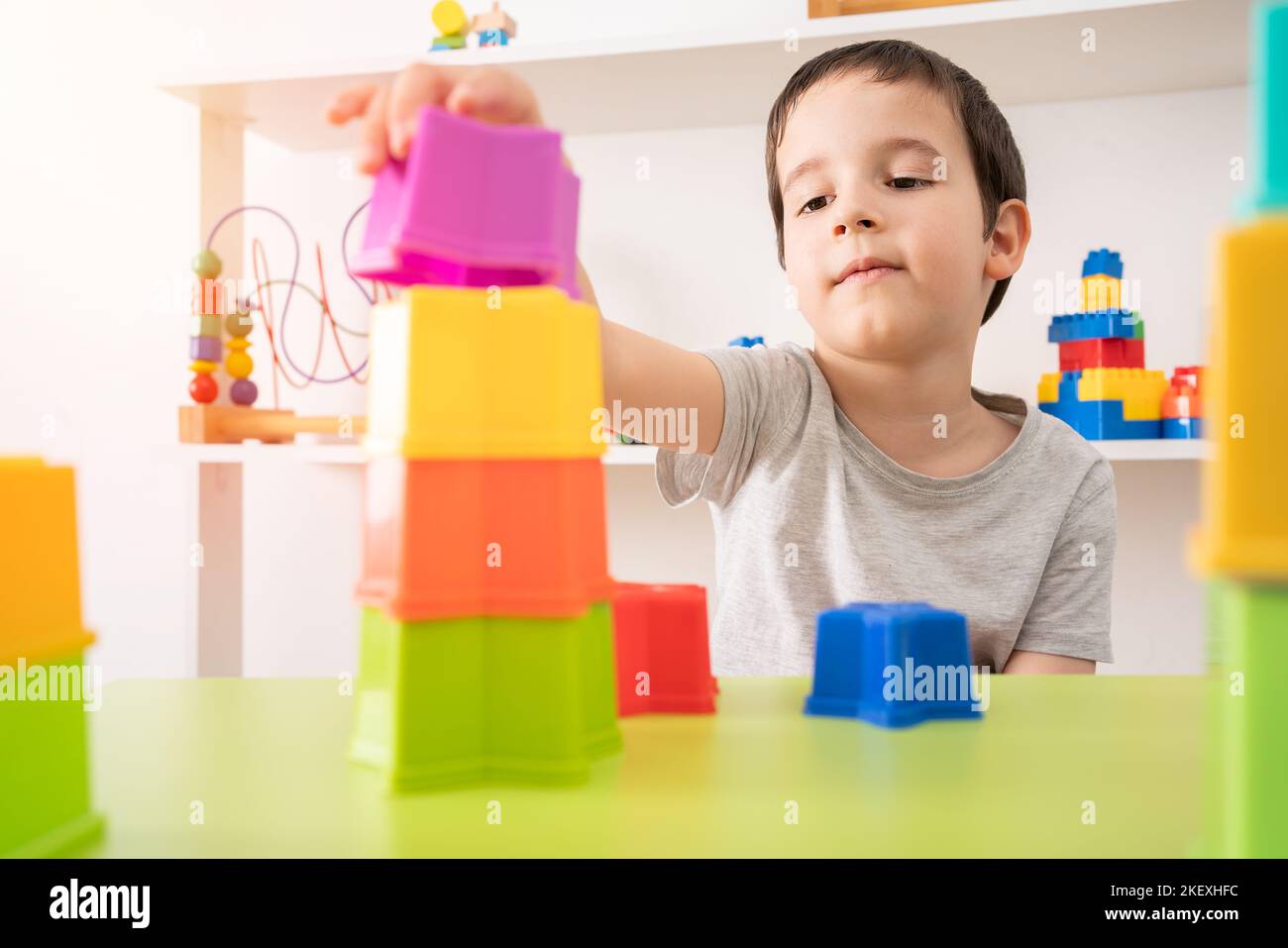 The building blocks of my future. An interested pre-school child building something with plastic blocks. Stock Photo