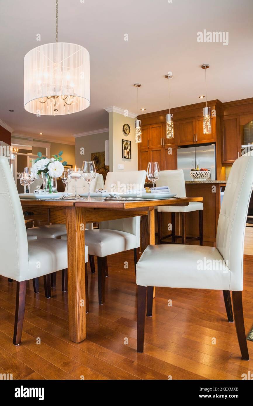 Dark stained oak wood table with white highback leather and wood