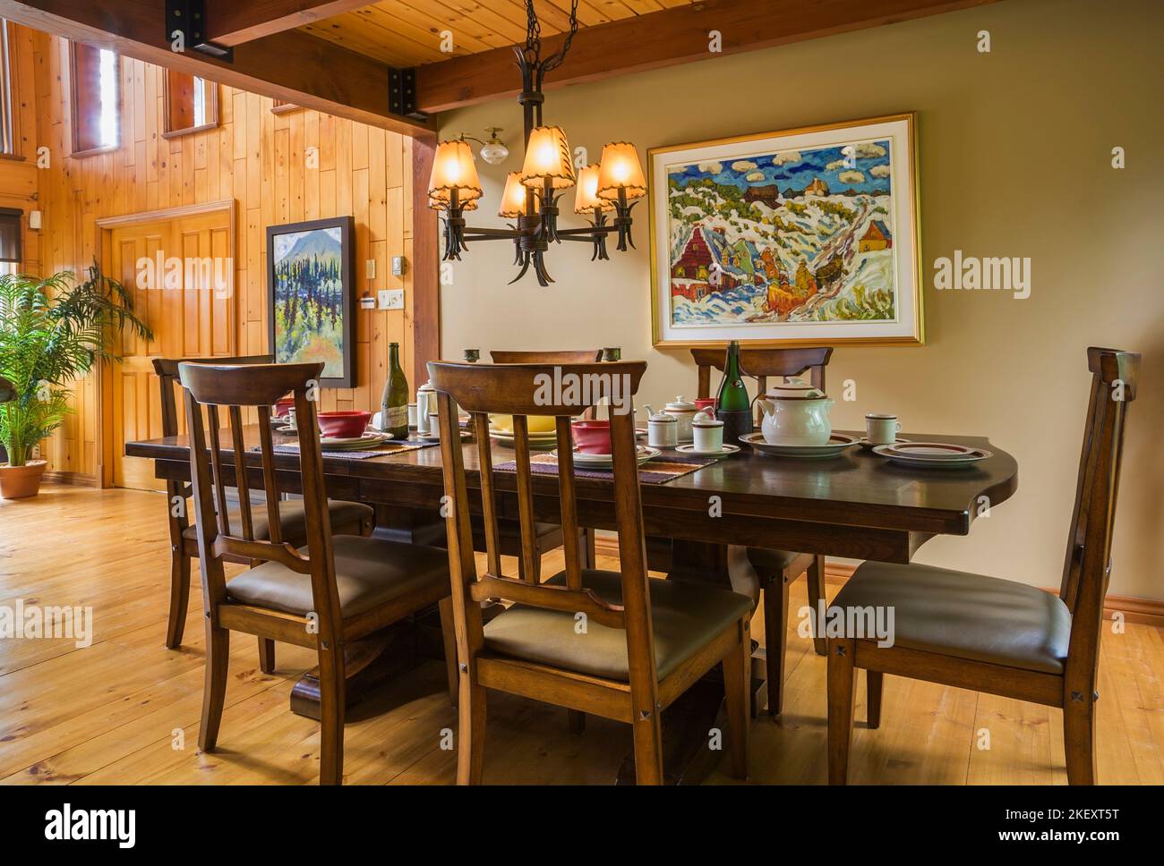 Set wooden dining table with highback tan leather padded sitting