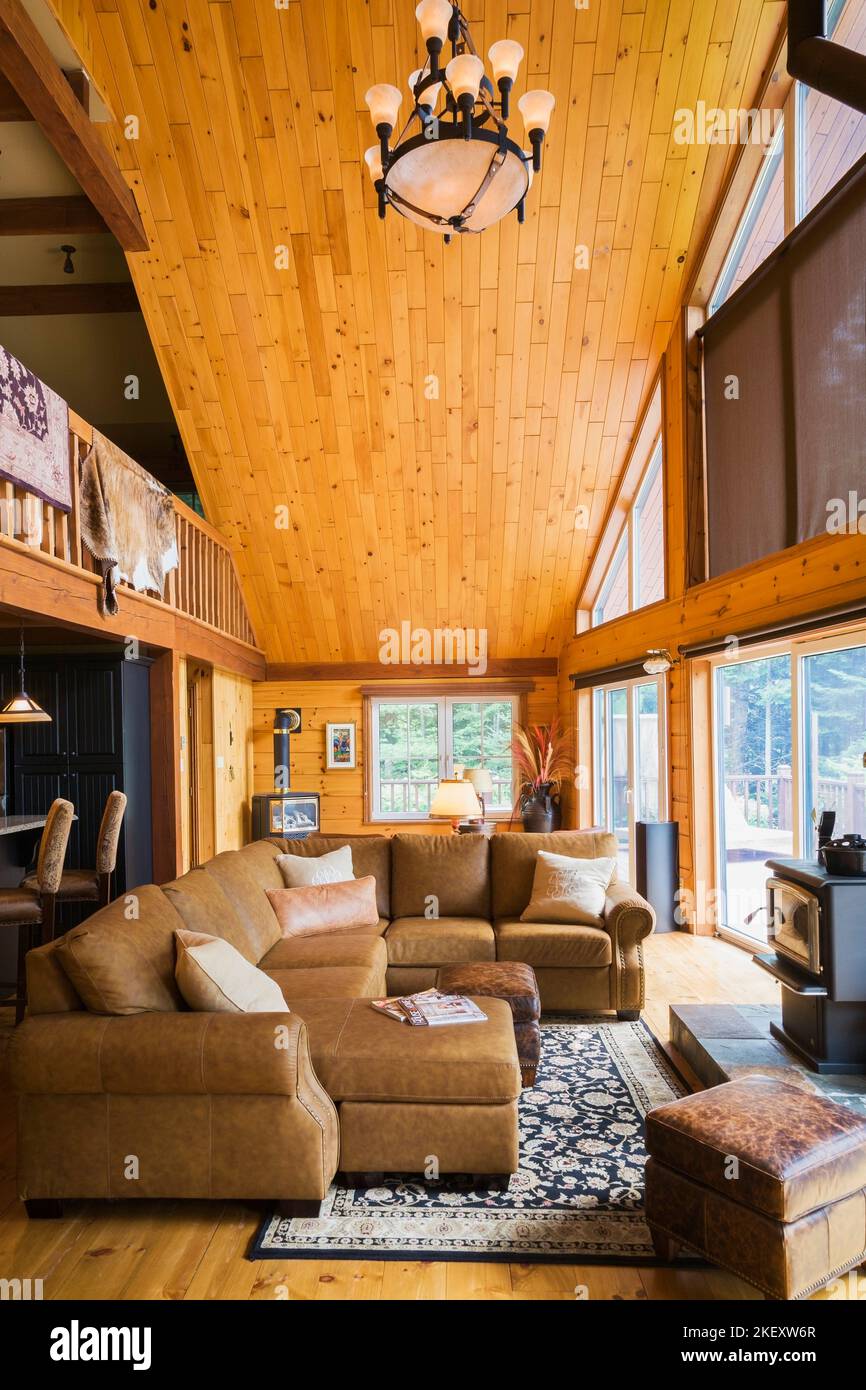 Tan leather sectional sofa in living room with view of kitchen island