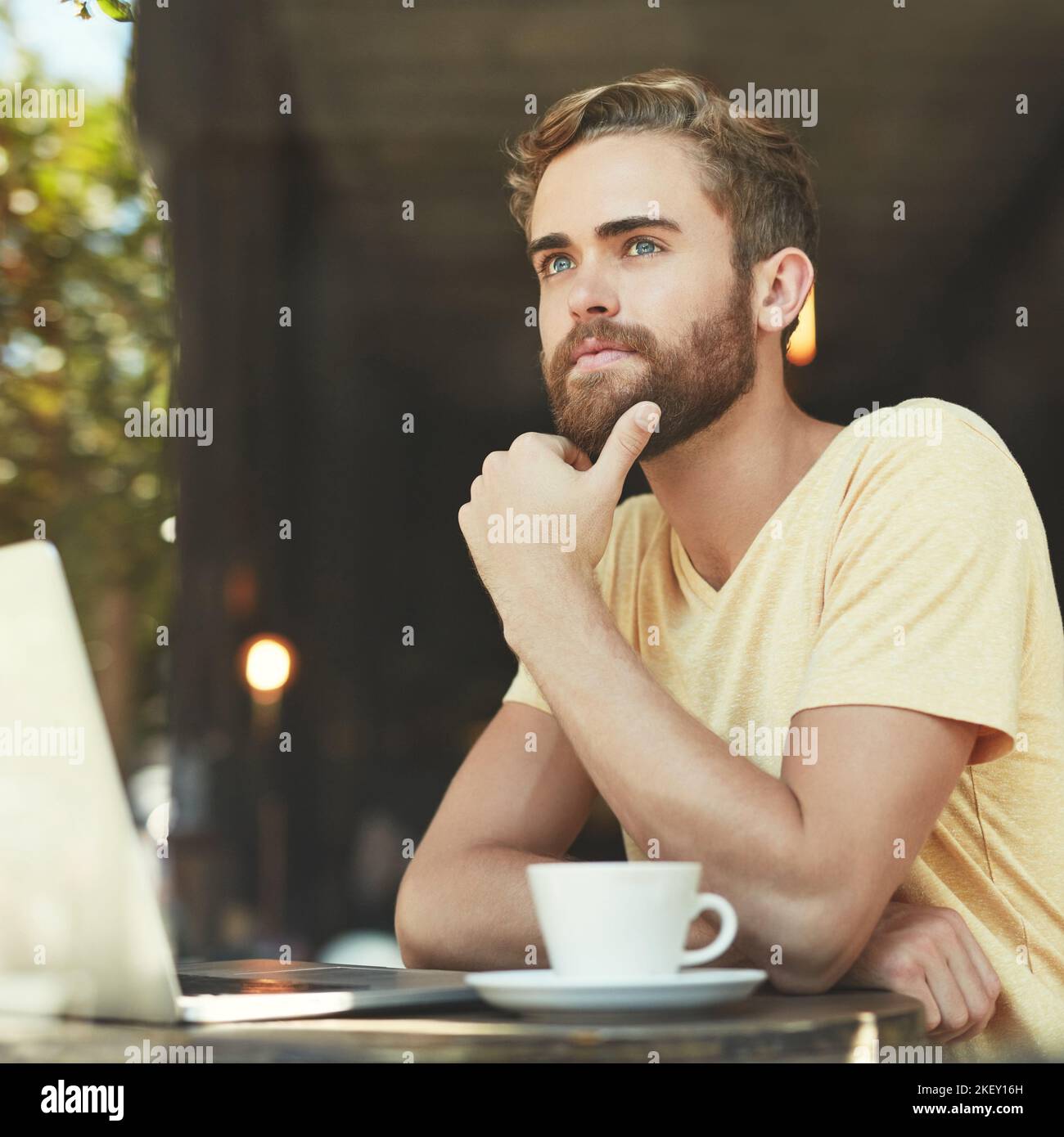 Searching for inspiration for his next blog. a young man using a laptop in a cafe. Stock Photo