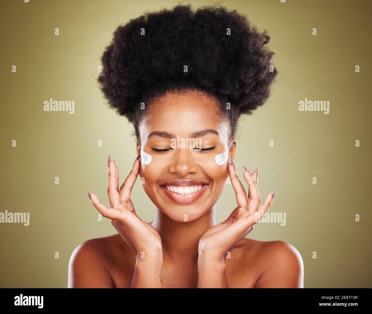 Cream, face and skincare black woman in studio for beauty, skin glow and shine for wellness goals, results and benefits advertising. Happy african Stock Photo