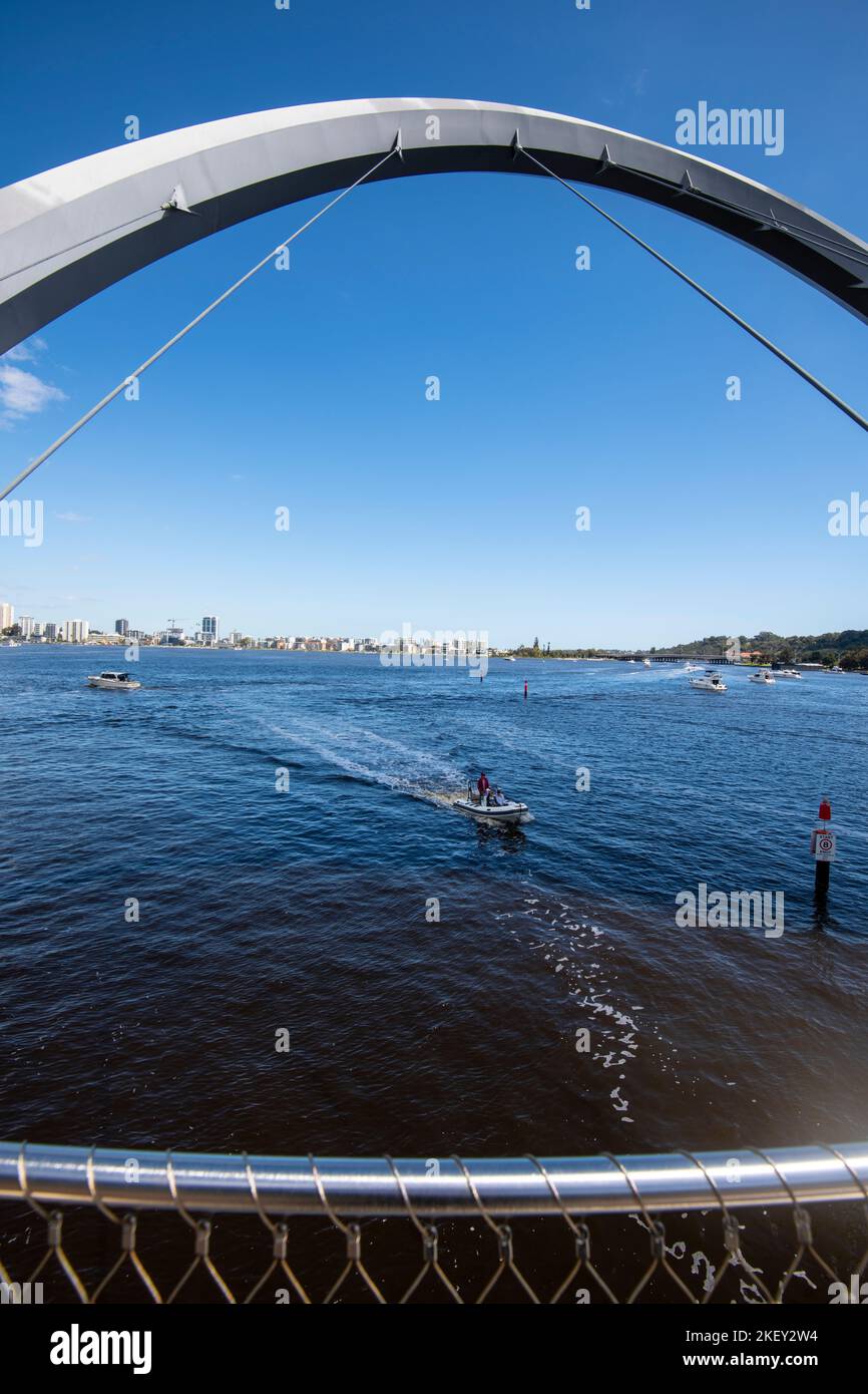 A view of a pleasure boat arriving at Queen Elizabeth Quay, Perth, Western Australia - taken through Swan River harbour pedestrian bridge steel arch. Stock Photo