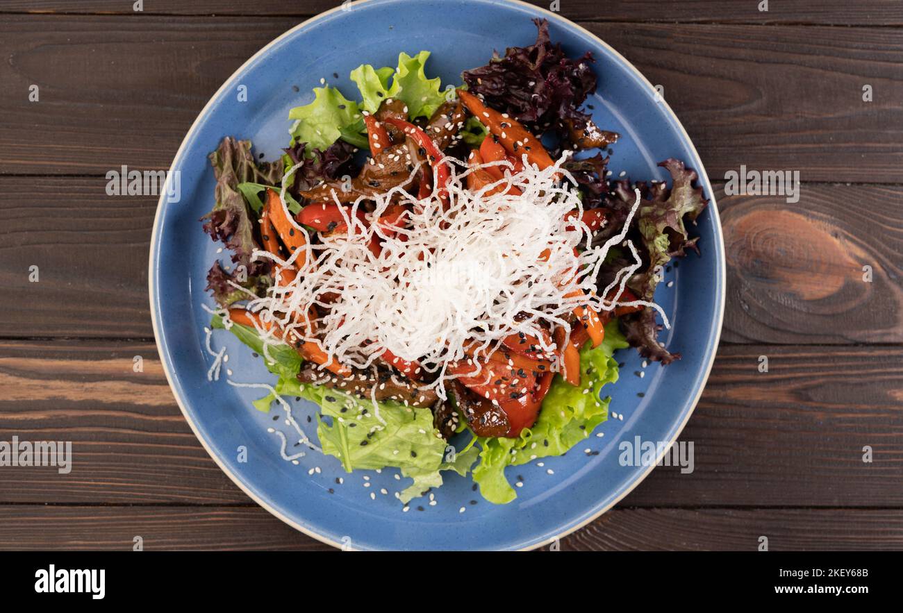 Thai Beef Salad with on wooden background, top view. Stock Photo