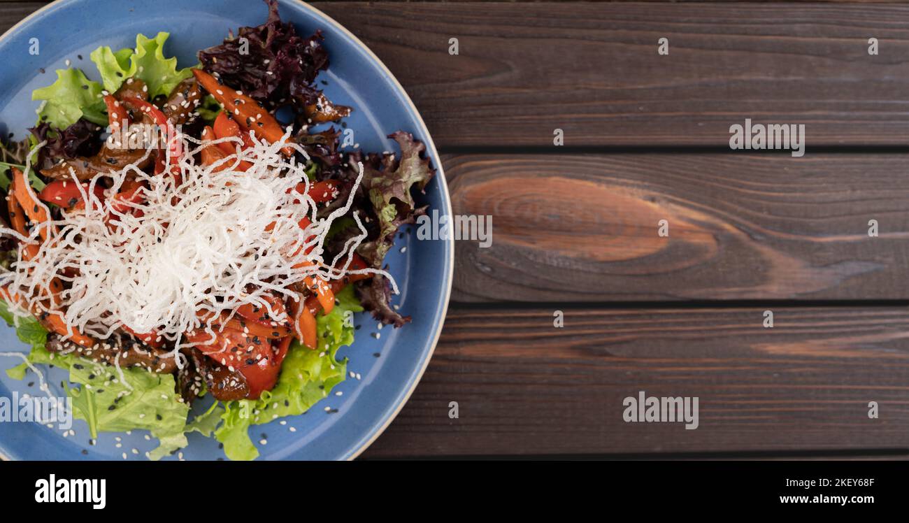 Thai Beef Salad with on wooden background, top view. Copy space Stock Photo