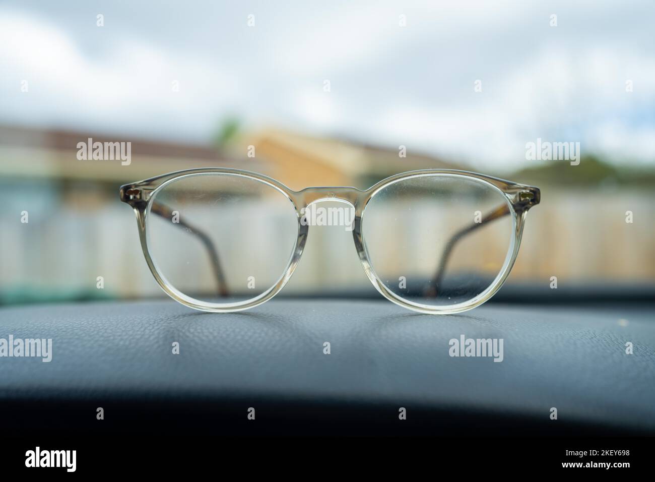 Clear fashionable glasses on the dashboard of a car in australia Stock Photo Alamy