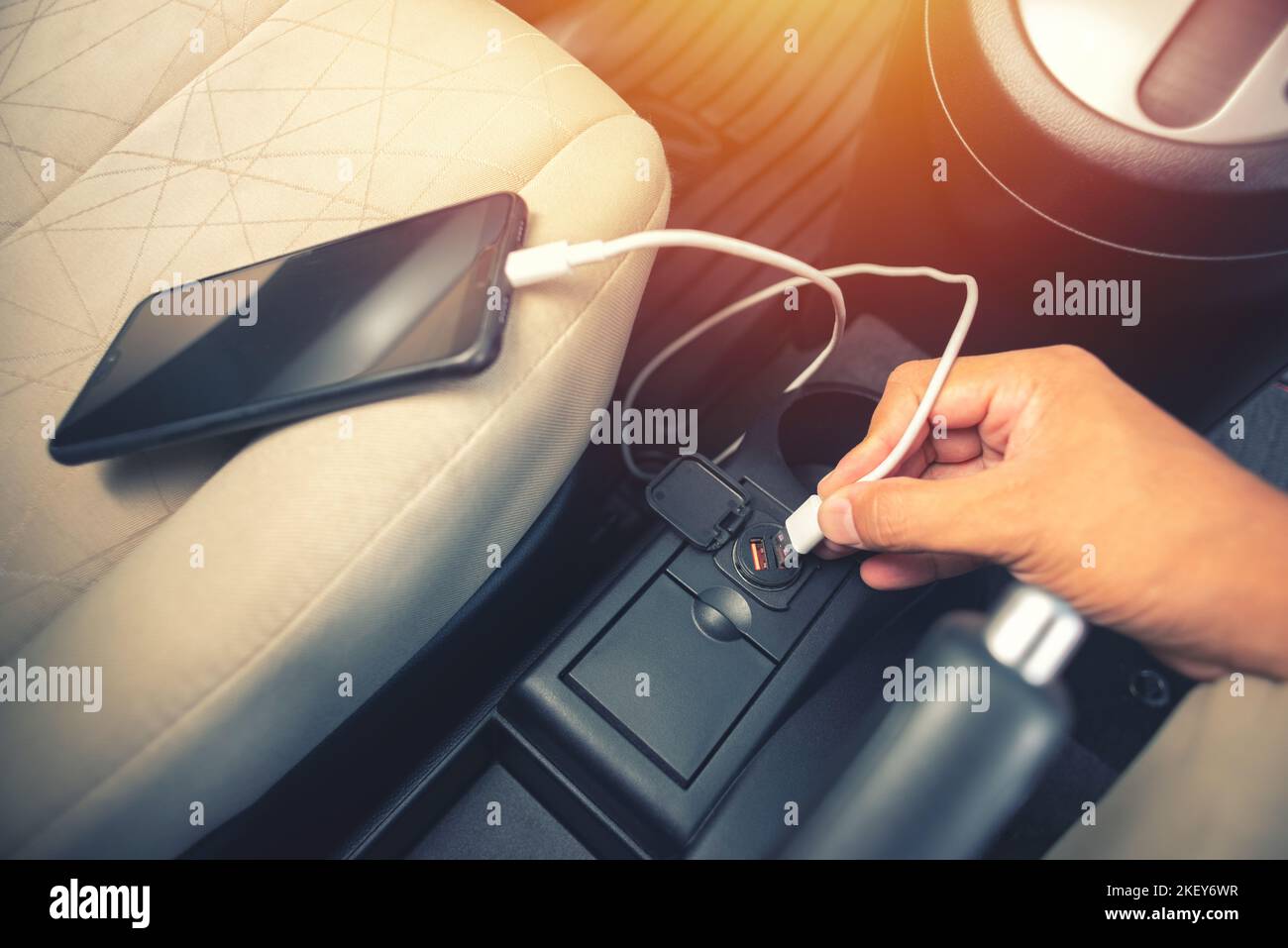 Charging smartphone battery with usb charger in the car Stock Photo - Alamy