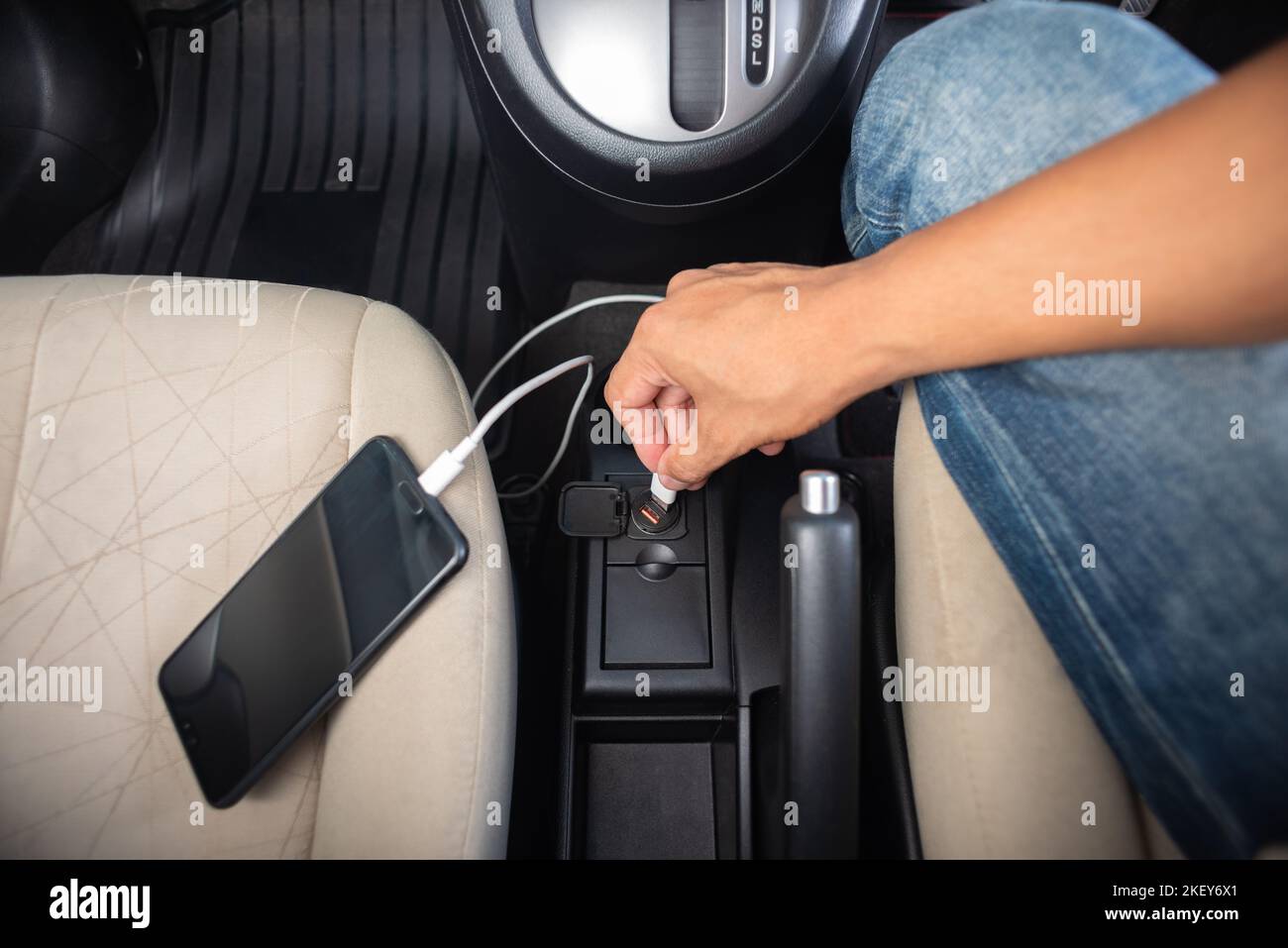 Charging smartphone battery with usb charger in the car Stock Photo - Alamy