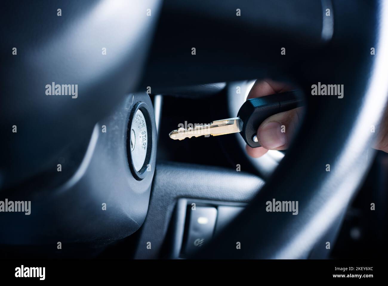 Putting the key into keyhole for ignition the engine. Start the car