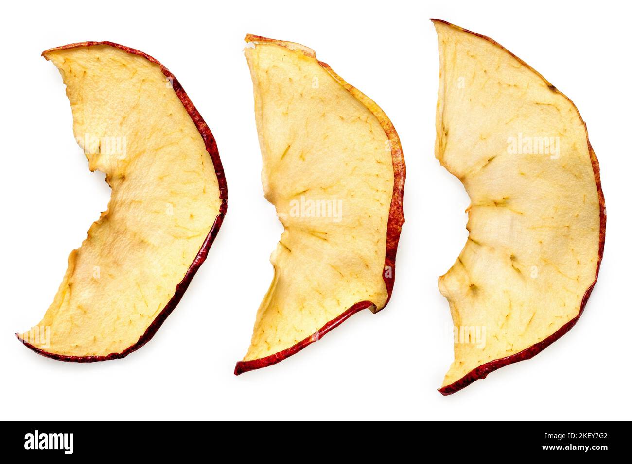 Three dried apple slices isolated on white. Top view. Stock Photo