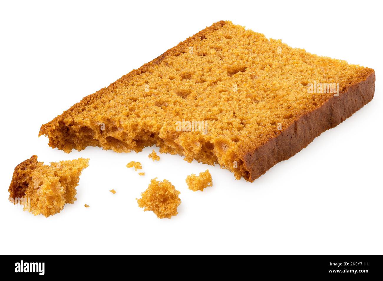 Partially eaten slice of spiced honey cake with crumbs isolated on white. Stock Photo