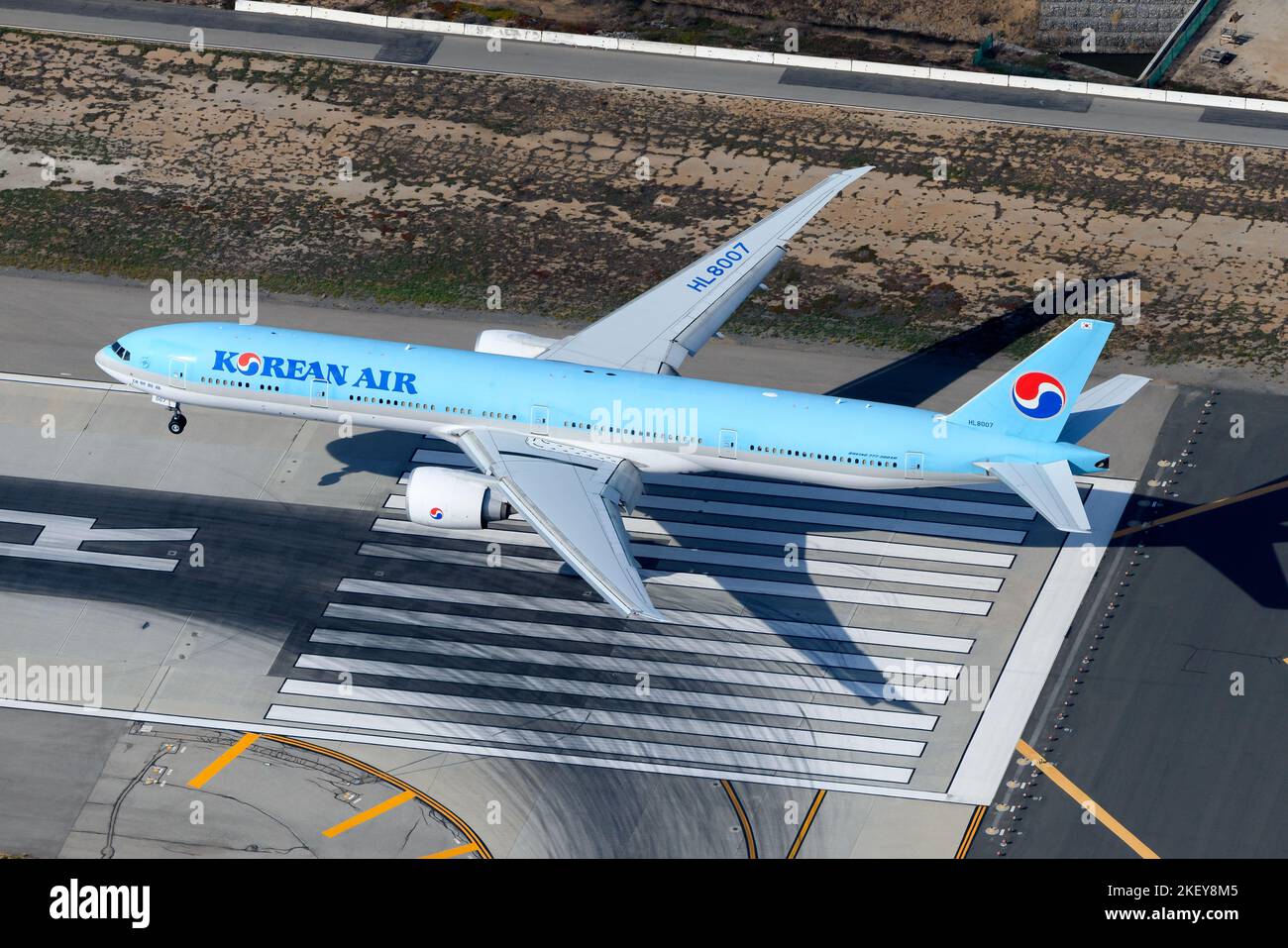 Korean Air Boeing 777 aircraft landing at airport runway. Airplane 777-300ER registered as HL8007 of Korean Air, also know as Korean Airlines. Stock Photo