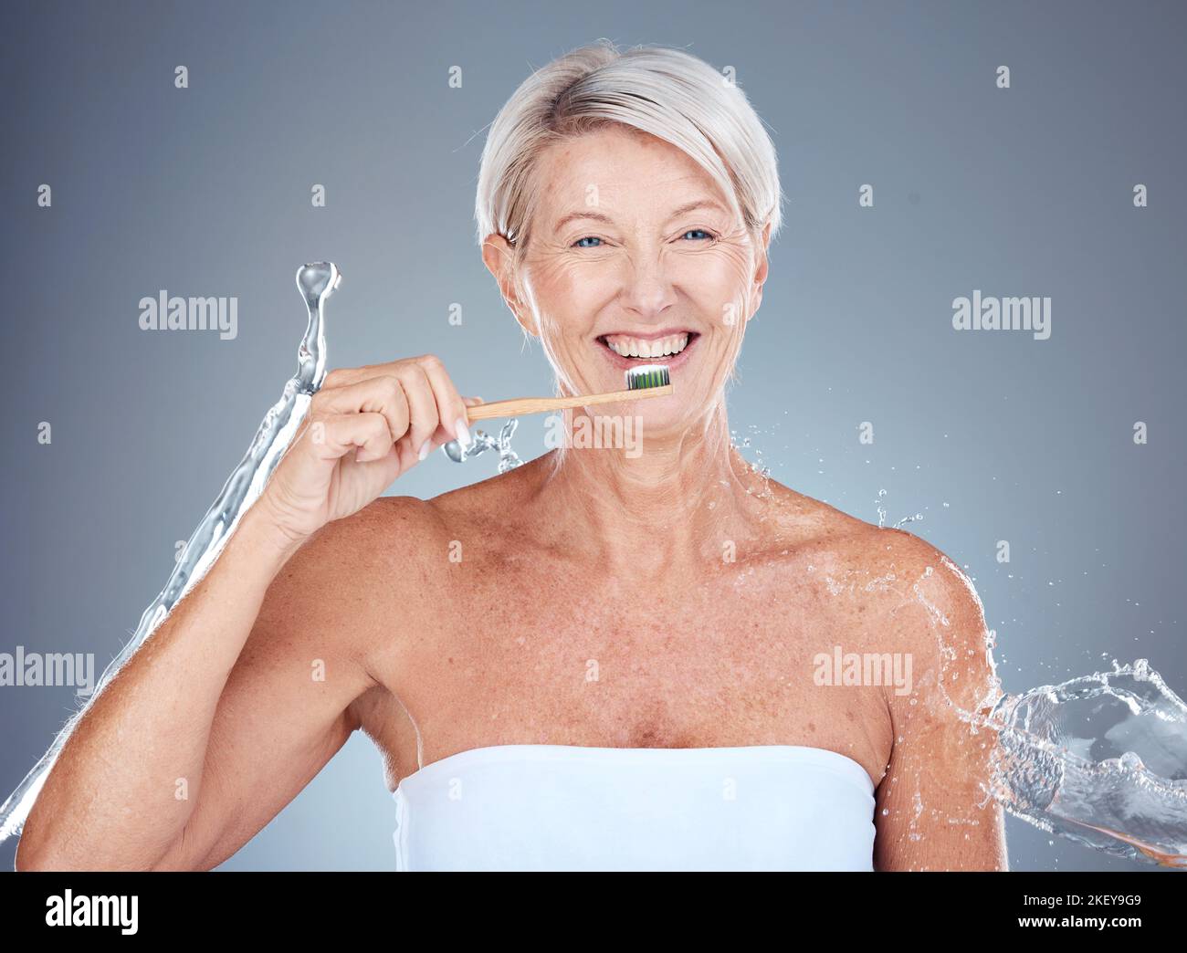 Toothbrush, portrait and senior woman dental healthcare studio mockup brushing teeth for dentist and whitening advertising. Smile of elderly model Stock Photo