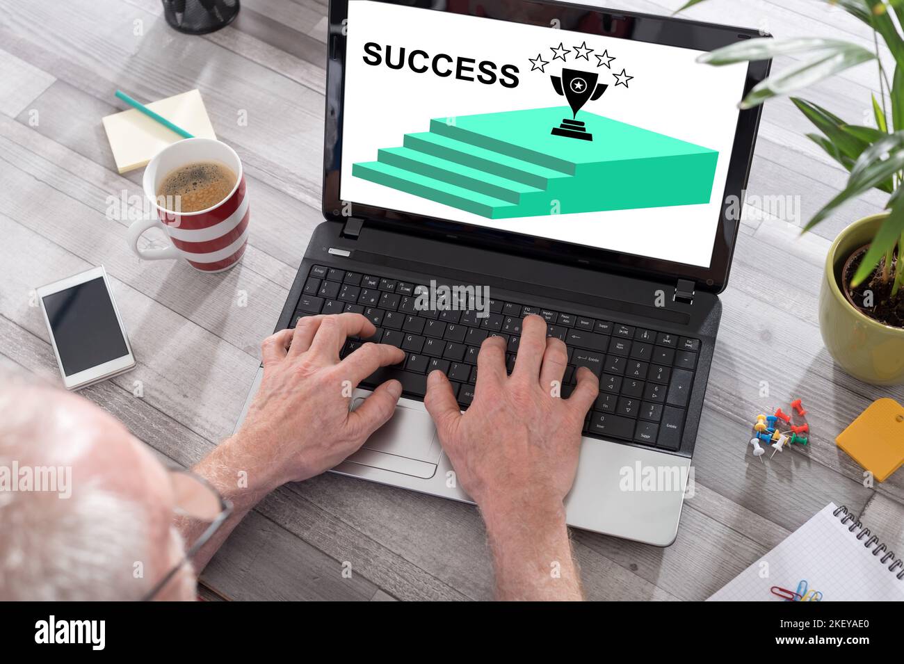 Success concept shown on a laptop used by a man Stock Photo - Alamy