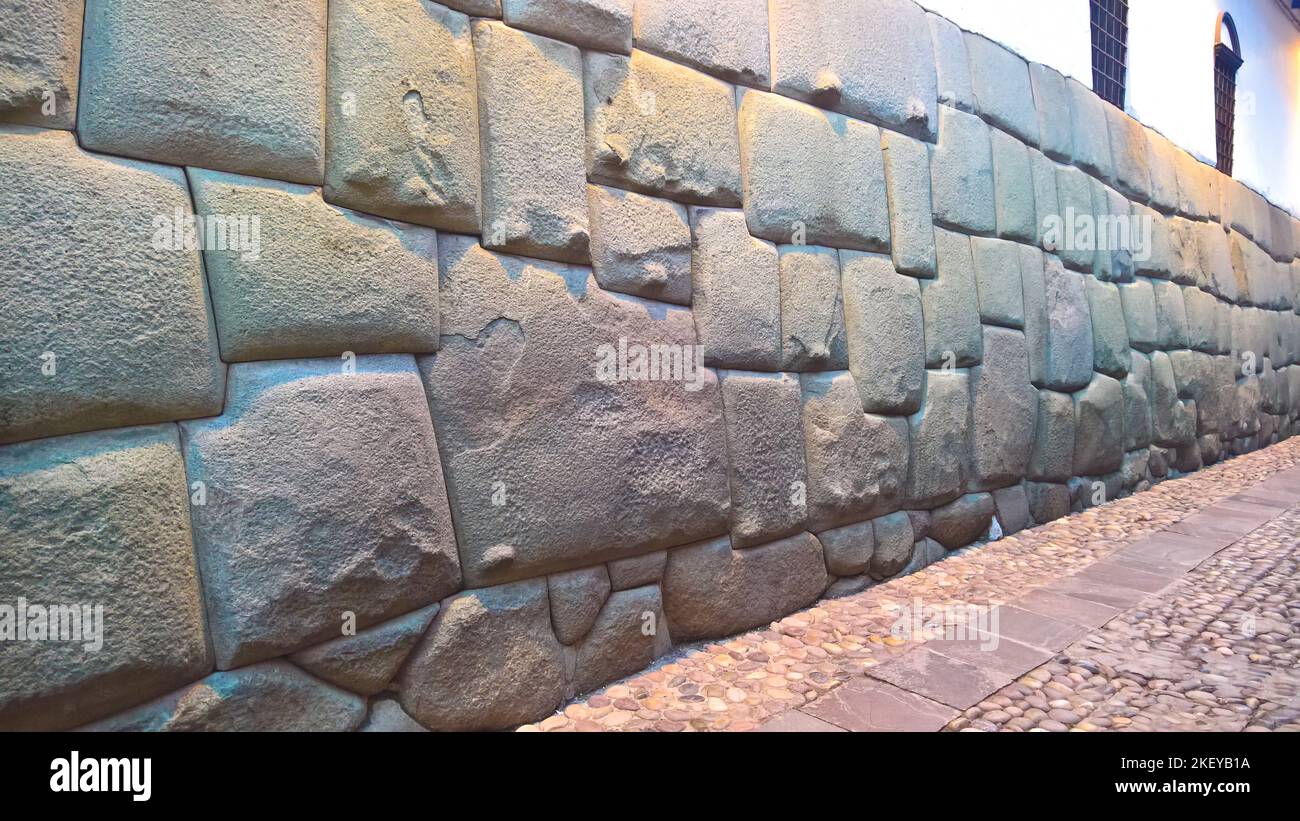 View to Twelve-angled stone aka Hatun Rumiyoc as a part of a wall of the palace of the Archbishop of Cuzco in Peru Stock Photo