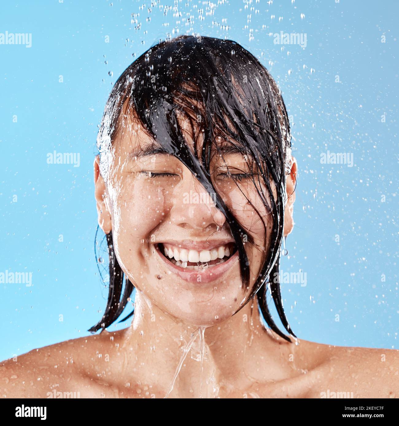 https://c8.alamy.com/comp/2KEYC7F/shower-water-and-happy-woman-with-smile-in-studio-for-skin-health-wellness-and-hygiene-happiness-beauty-and-wet-asian-model-cleaning-or-washing-2KEYC7F.jpg