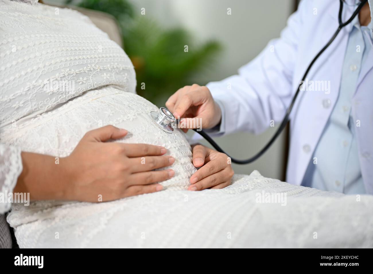 closeup and cropped shot, Female doctor or obstetrician listening baby