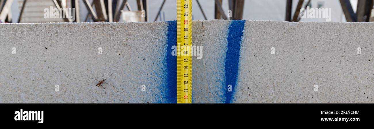 Measuring ruler on a concrete wall texture. The concept of renovation ...