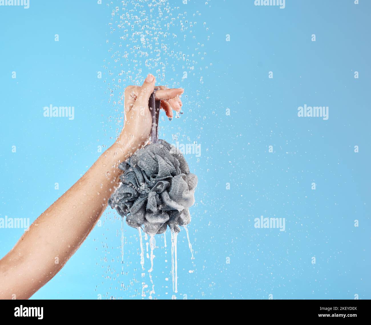Shower, water and hands with a loofah for luxury wellness, cleaning and ...