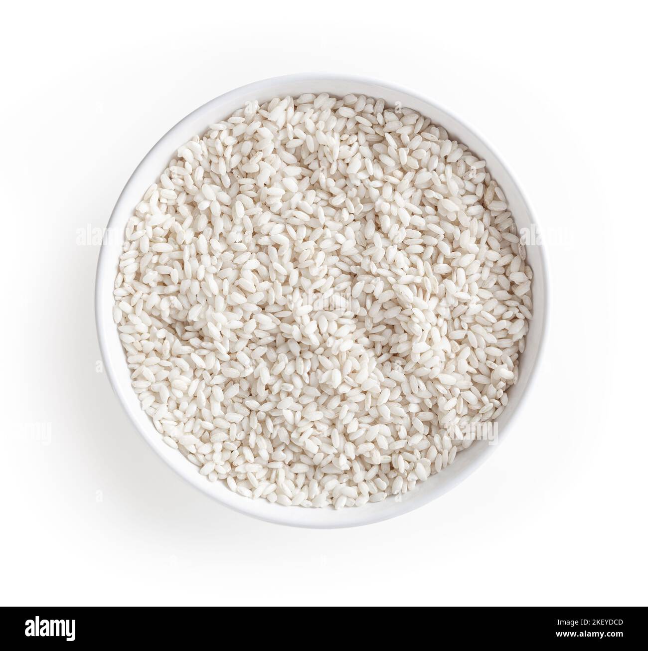 Uncooked arborio rice in white bowl isolated on white background with