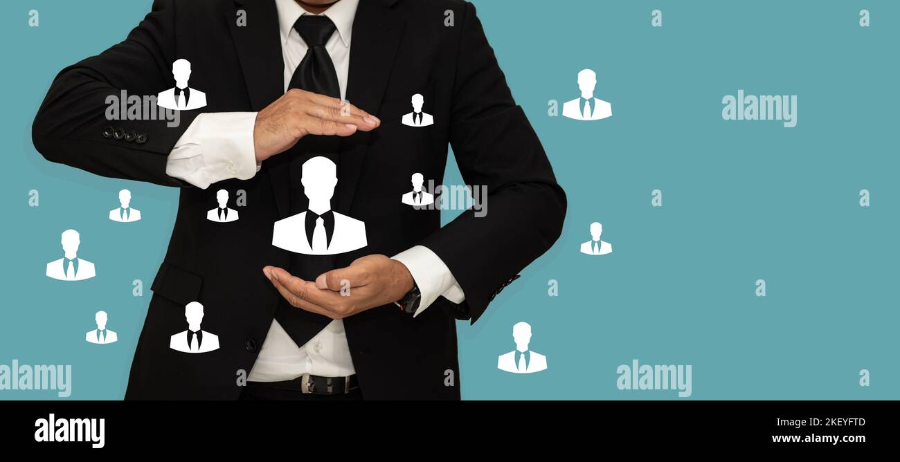 HRM or Human Resource Management, Business man holding human icons in hand with copy space. Stock Photo