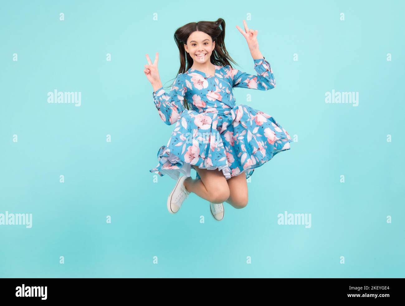 Full size photo of positive teen girl jump with movement summer dress ...