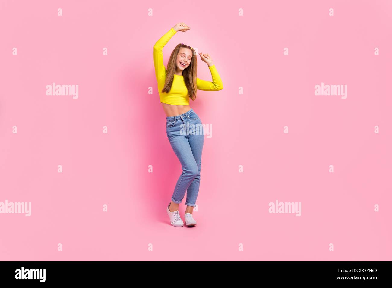 Full length photo of excited dreamy school girl dressed yellow crop top