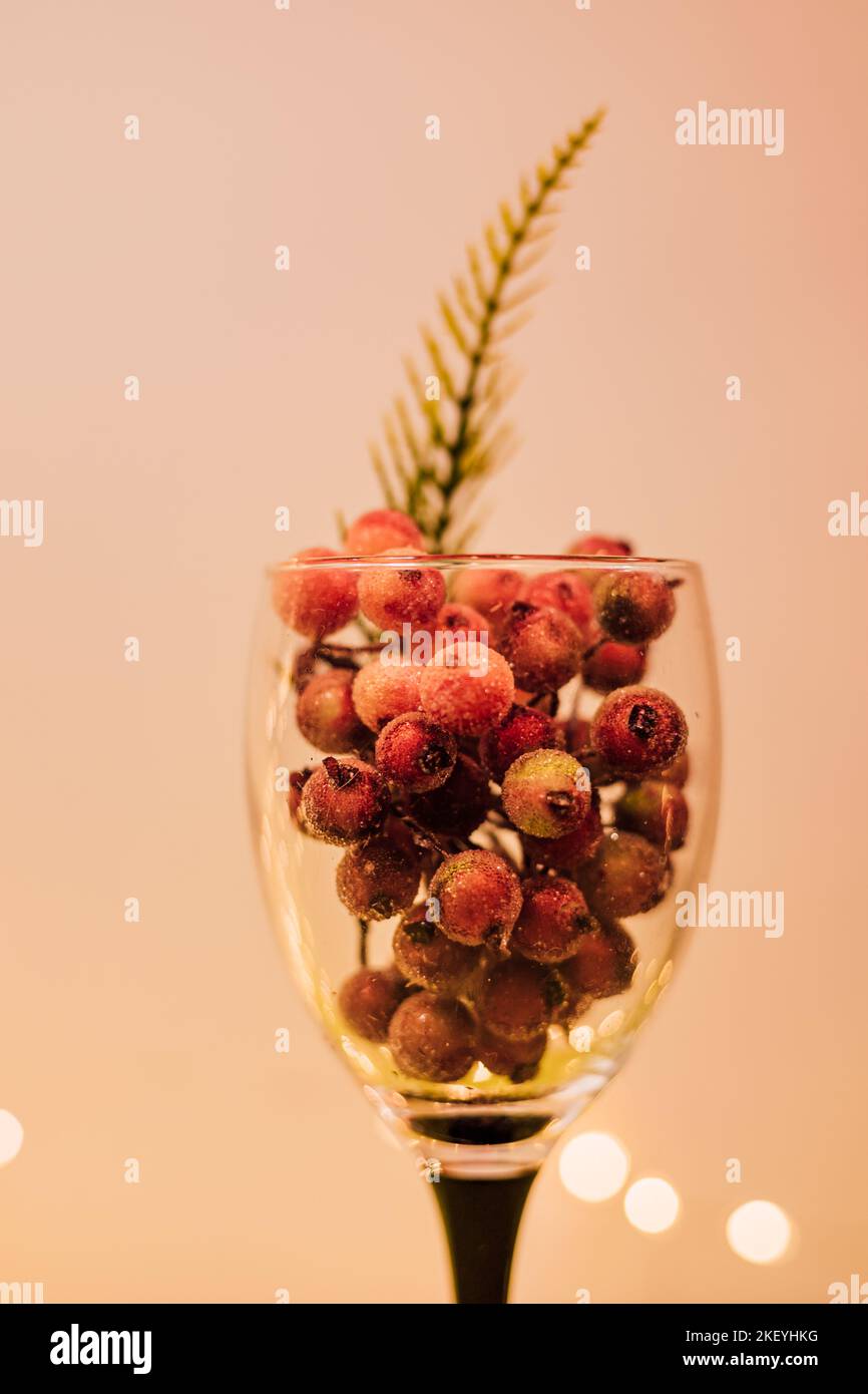 Red berries in a wine glass. Stop alcohol. Sober lifestyle Stock Photo