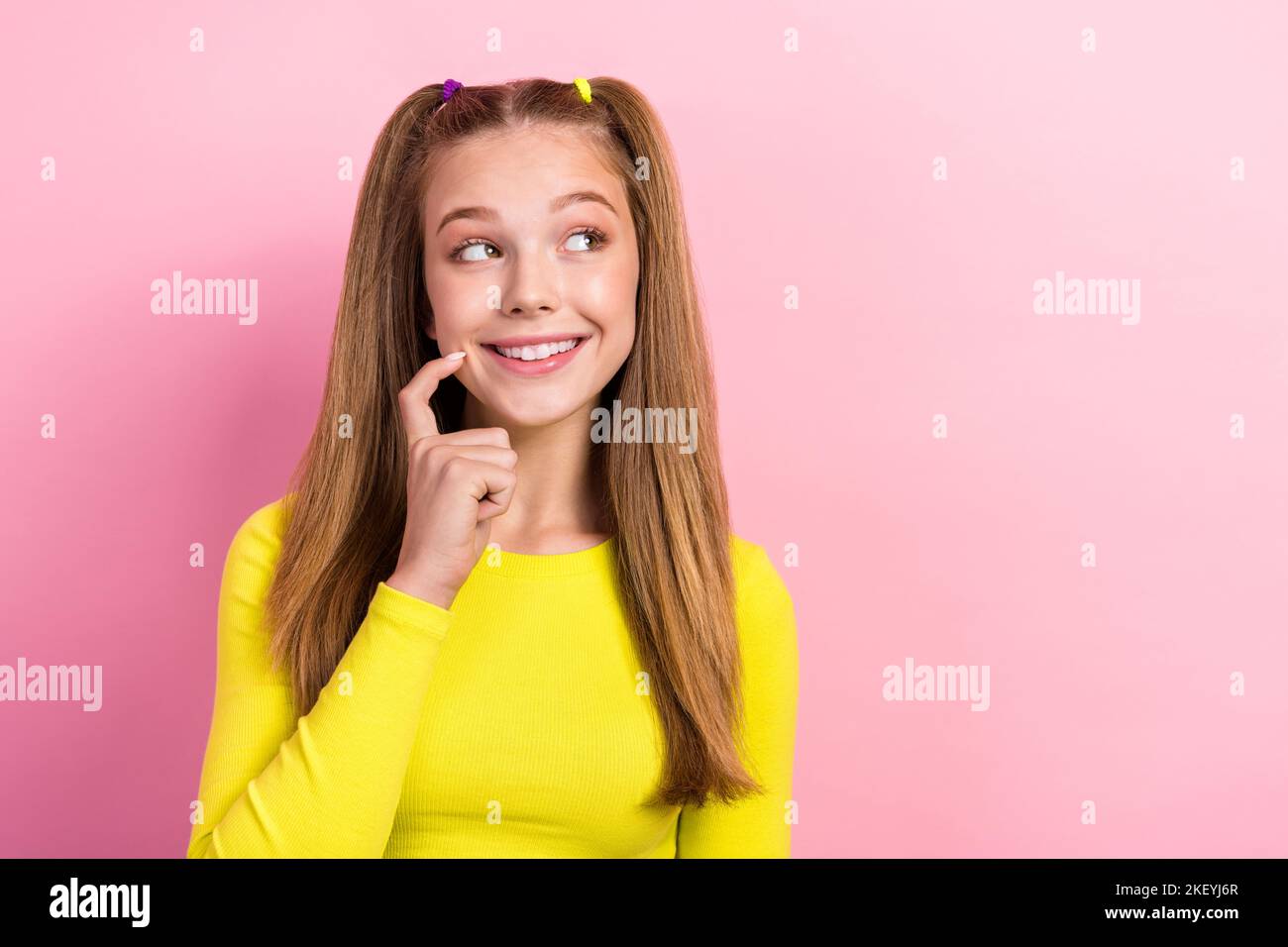 Portrait of cute positive girl straight hairdo yellow long sleeve look