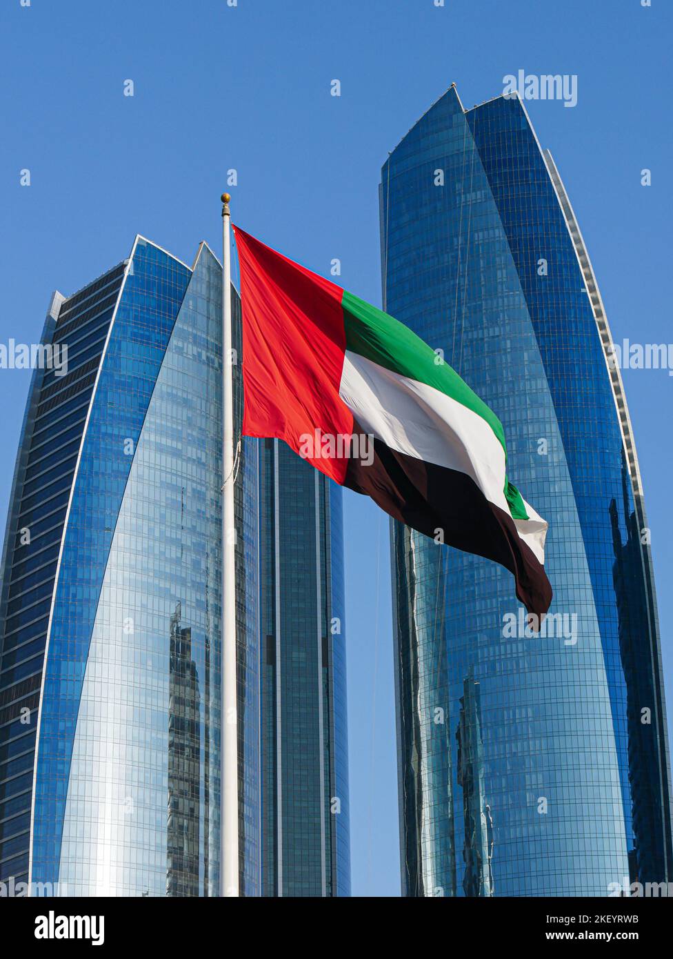UAE Flag flying with Skyscrapers in the background, Abu Dhabi, United Arab Emirates Stock Photo