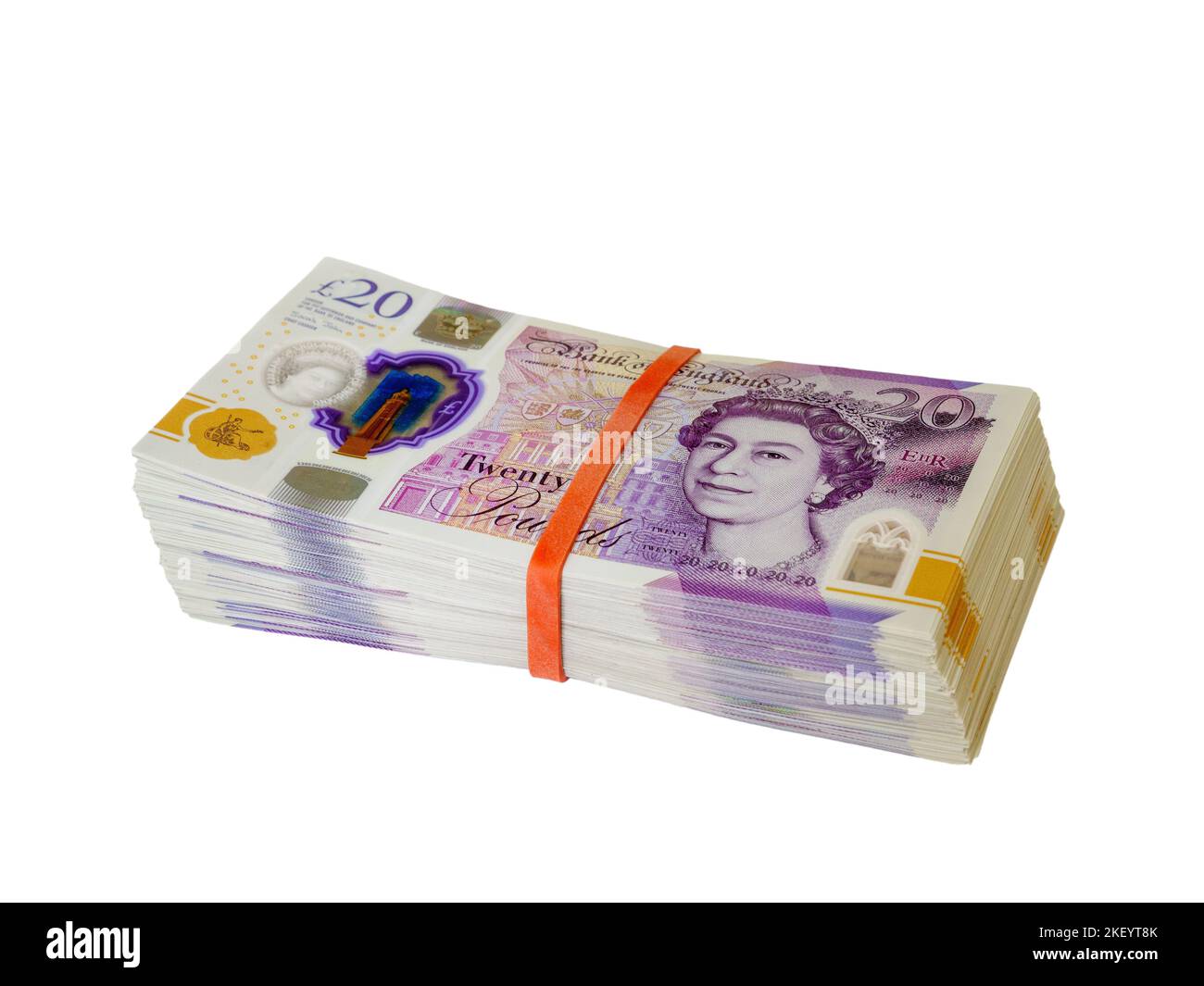 Large stack of money in the form of 20 British pound notes amounting to thousands in cash against a white cutout background Stock Photo