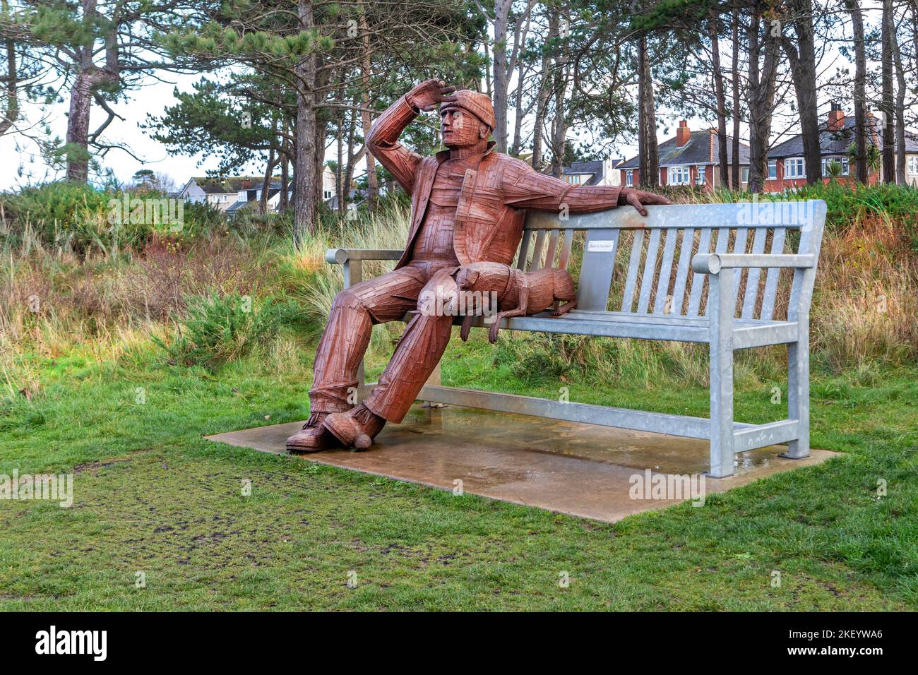The sculpture entitled “Big Fella” is of a man and his dog taking in the beautiful sea views. The giant steel statue is 12 feet tall, Stock Photo